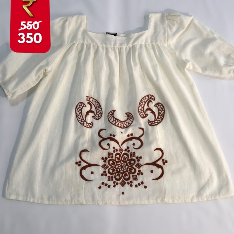 white top with brown embroidery